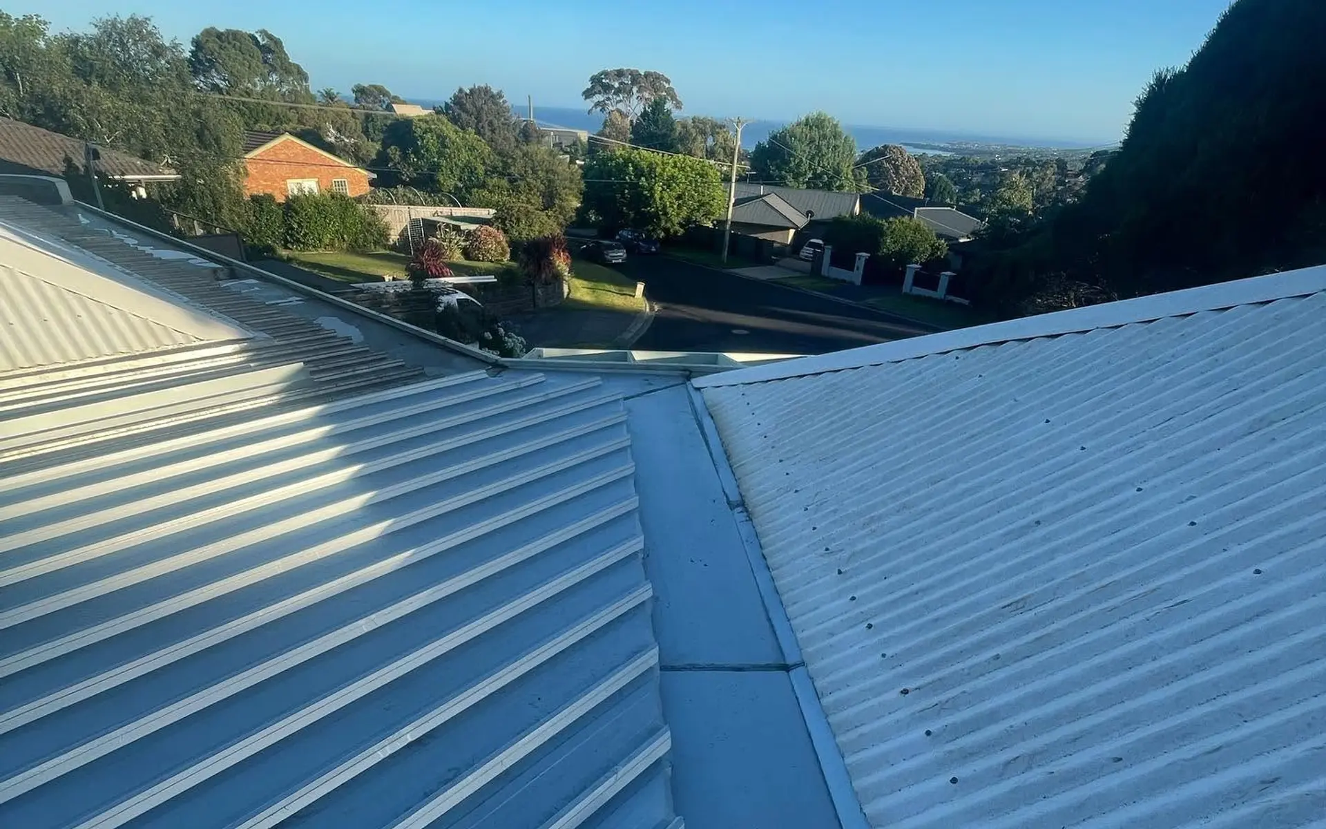 New Colorbond roof on a house looking out over a hillside suburb