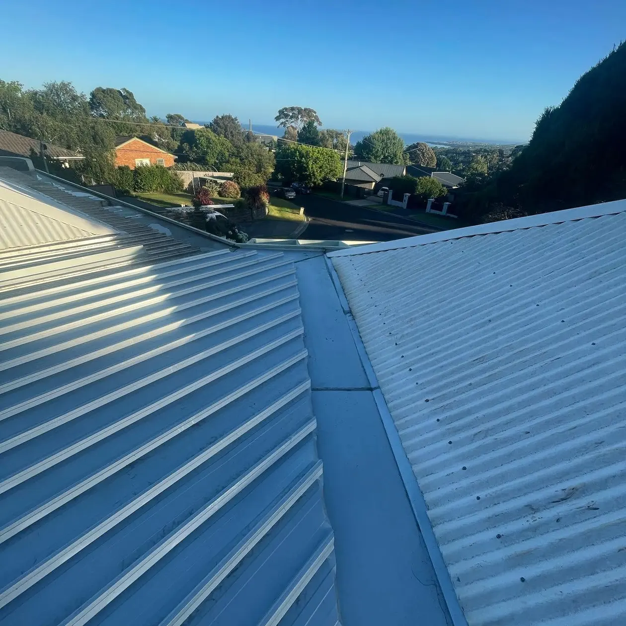 New Colorbond roof on a house looking out over a hillside suburb