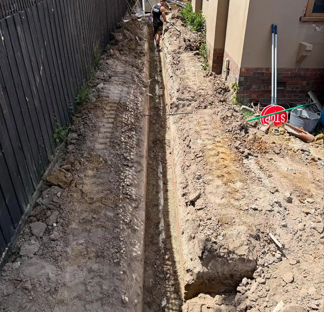 Drainage trench excavated beside a house