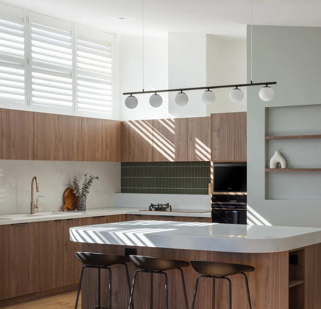 Kitchen island bench and timber cabinetry in a completed renovation