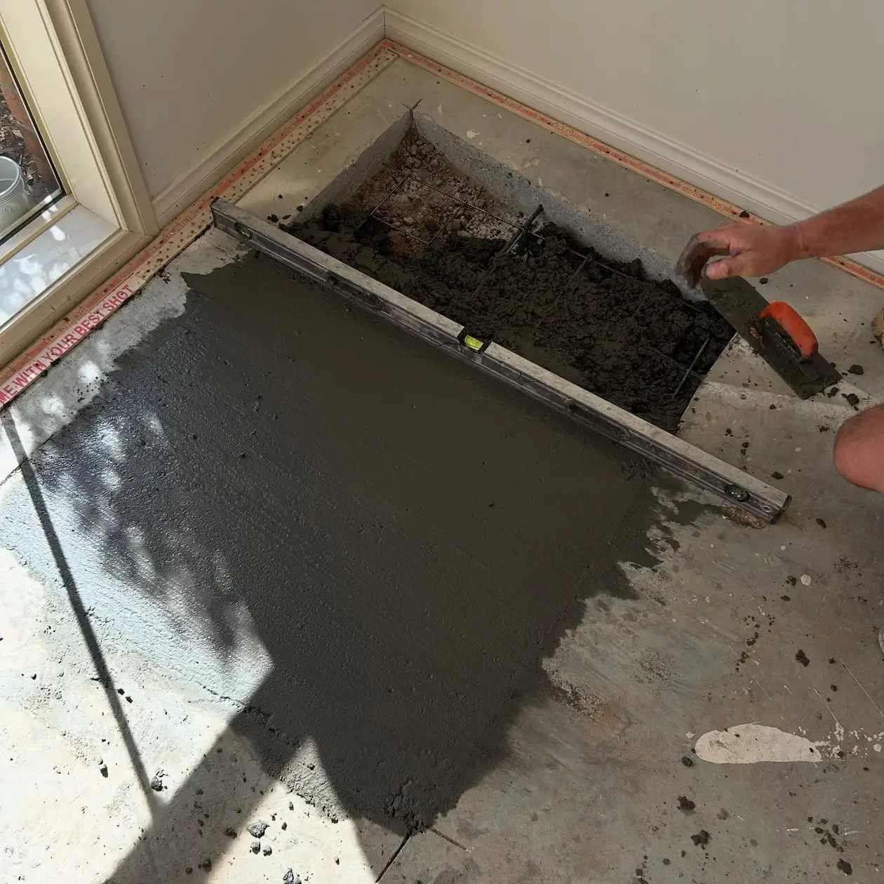 Floor being screeded during a wet area renovation