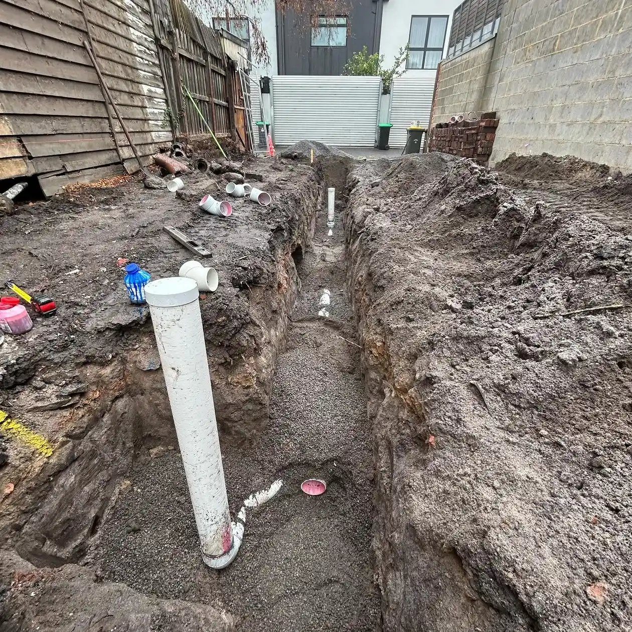 New stormwater pipes laid in an open trench in a back yard